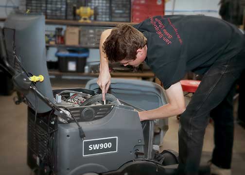 Replacing a pad on a commercial floor scrubber